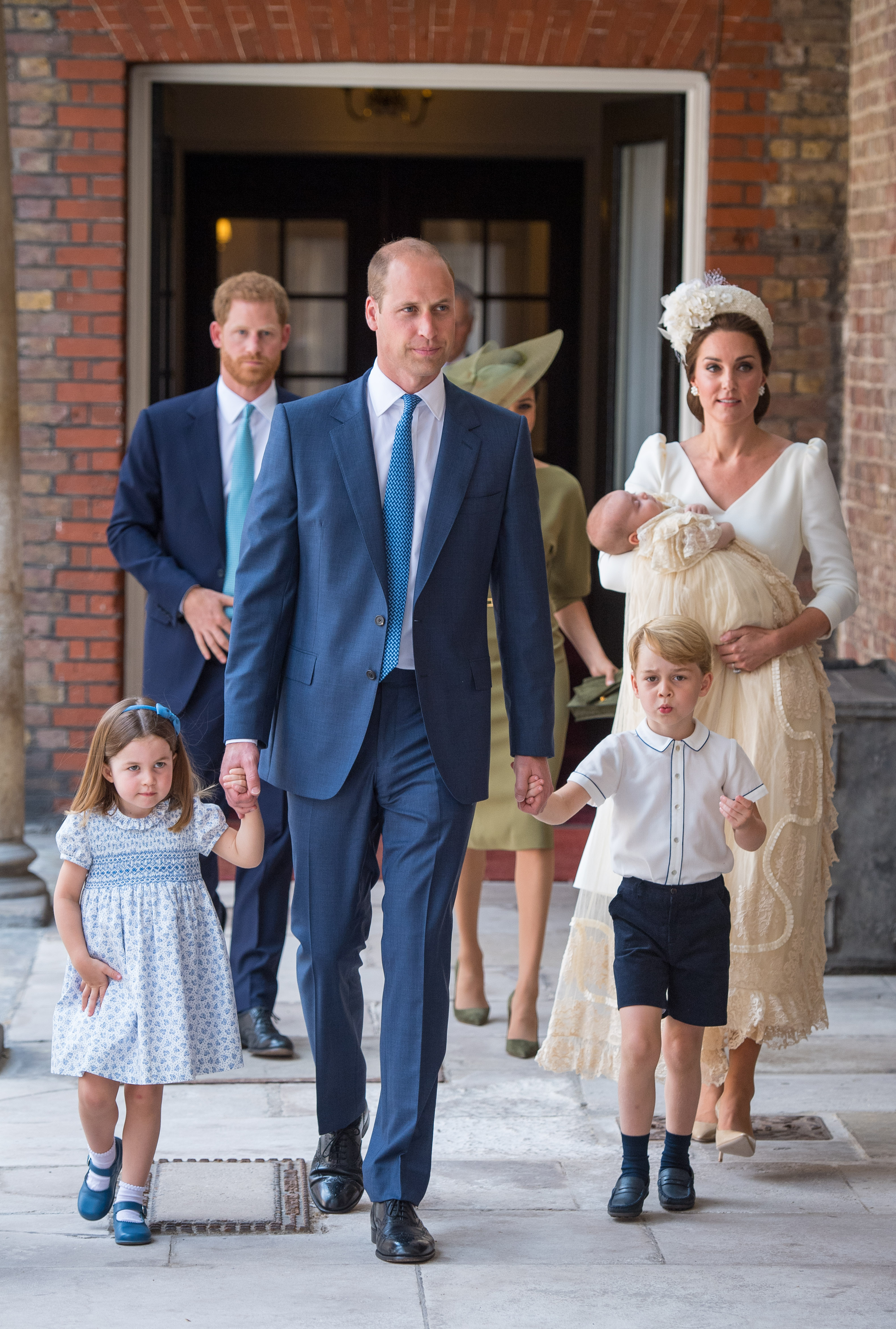 LONDON, ENGLAND - JULY 09: Princess Charlotte and Prince George hold the hands of their father, Prince William, Duke of Cambridge, as they arrive at the Chapel Royal, St James's Palace, London for the christening of their brother, Prince Louis, who is being carried by their mother, Catherine, Duchess of Cambridge on July 09, 2018 in London, England. (Photo by Dominic Lipinski - WPA Pool/Getty Images)