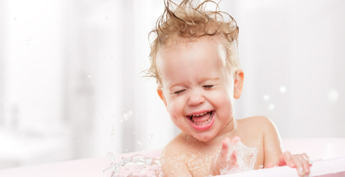 happy funny baby  laughing and bathed in the bath